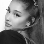 Ariana Grande posing for a portrait with her signature high ponytail.