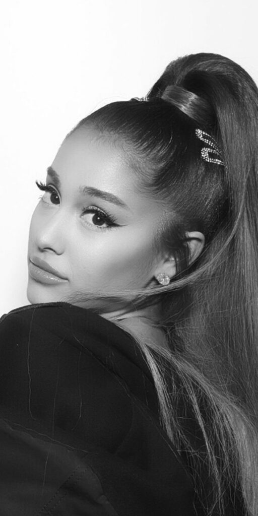 Ariana Grande posing for a portrait with her signature high ponytail.