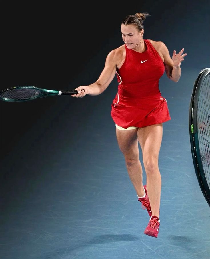 A powerful shot of tennis player Aryna Sabalenka mid-serve, showcasing athletic form on the court.
