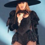 Beyoncé posing for a portrait in an elegant stage-inspired outfit.