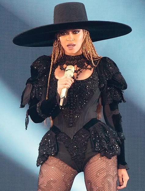 Beyoncé posing for a portrait in an elegant stage-inspired outfit.