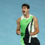A vibrant photo of tennis player Carlos Alcaraz celebrating a point victory.
