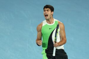 A vibrant photo of tennis player Carlos Alcaraz celebrating a point victory.