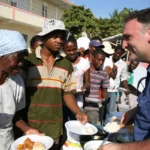 Chef José Andrés working alongside World Central Kitchen volunteers to distribute meals.