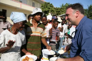 Chef José Andrés working alongside World Central Kitchen volunteers to distribute meals.
