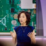 Dr. Fei-Fei Li, AI researcher and professor, speaking at a conference event.