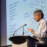 Geoffrey Hinton headshot profile with a subtle digital neural network graphic overlay representing the deep learning pioneer.
