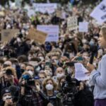Activist Greta Thunberg speaking passionately at a climate rally