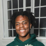 An energetic portrait of streamer IShowSpeed, Darren Watkins Jr smiling warmly.