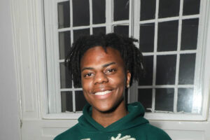 An energetic portrait of streamer IShowSpeed, Darren Watkins Jr smiling warmly.