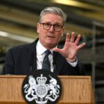 British Prime Minister Keir Starmer speaking at a podium amidst a growing Labour Party leadership crisis.