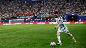 Lionel Messi dribbling a soccer ball during a match.