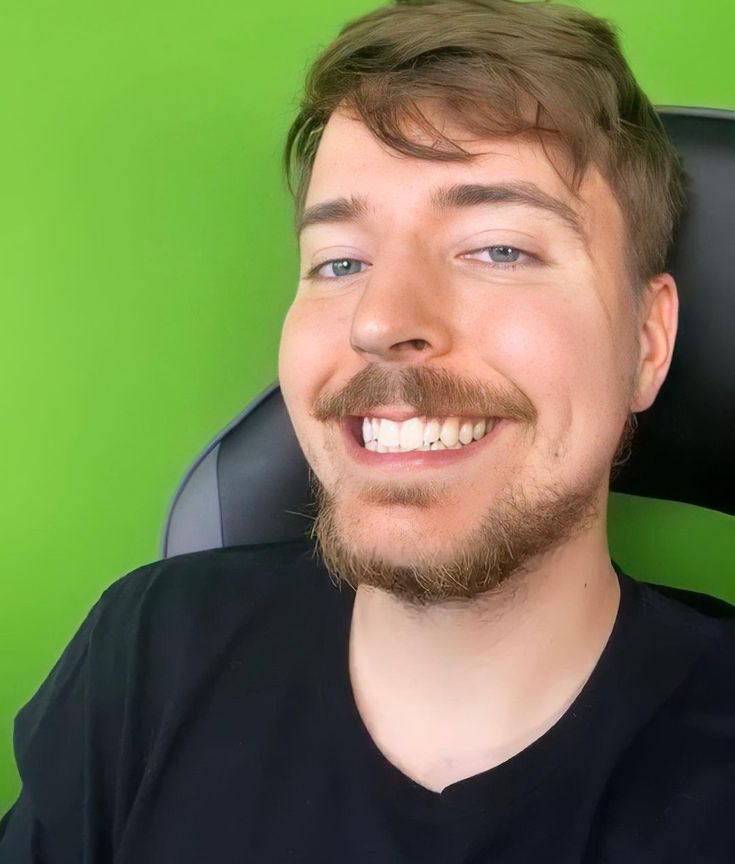 ​A friendly headshot of YouTube creator MrBeast, smiling directly at the camera with his signature short brown hair and light beard.