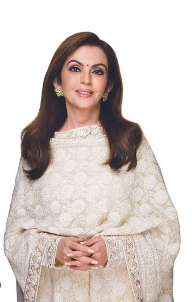 A portrait of Indian philanthropist and businesswoman Nita Ambani, dressed in elegant traditional Indian attire with intricate embroidery, smiling warmly.