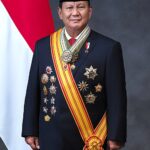 Prabowo Subianto, President of Indonesia, in a suit and traditional songkok cap.