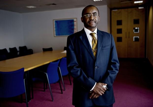 A professional portrait of Zimbabwean businessman and philanthropist Strive Masiyiwa, wearing glasses and a formal dark suit.