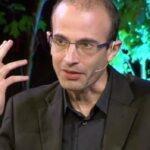 Author Yuval Noah Harari speaking on stage at a lecture