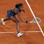 A dynamic photo of tennis star Coco Gauff tracking the ball down the court with intense concentration.