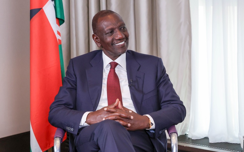 Professional portrait of William Ruto, President of Kenya, smiling in formal attire.